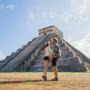 Young Caucasian  heterosexual couple on the  background of Chichen Itza pyramid in Mexico